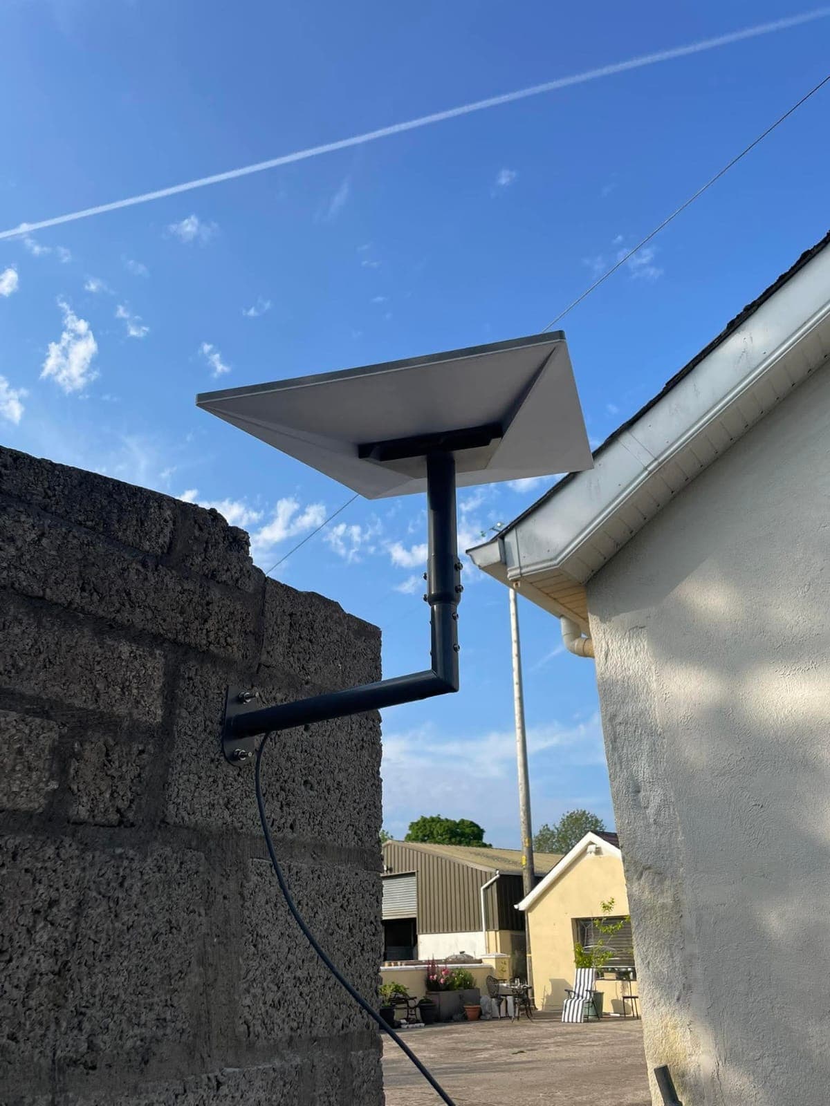 Wall-mounted Starlink dish installation