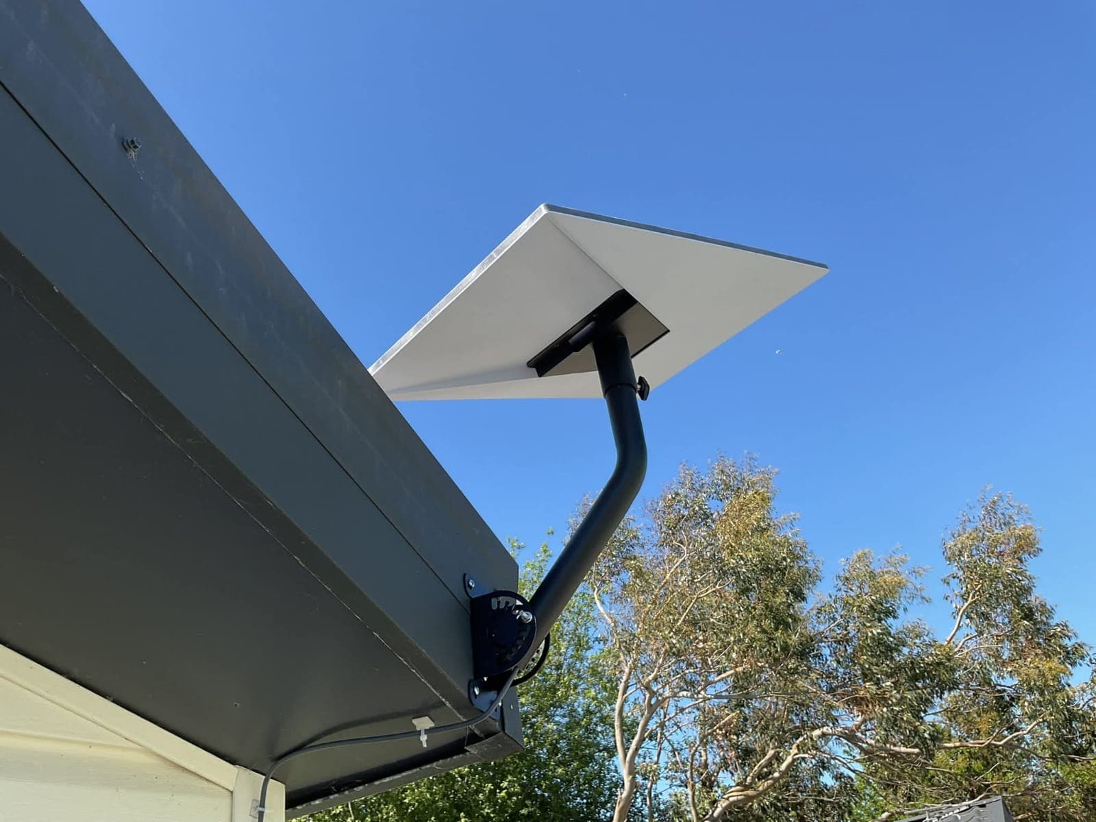 Starlink dish mounted above a roofline