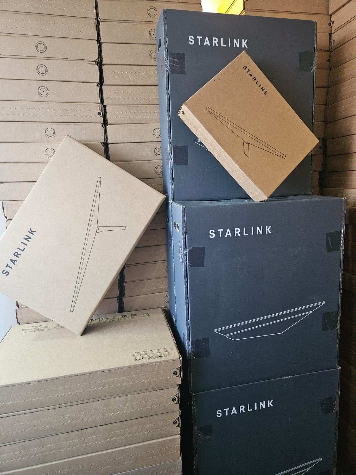 Starlink boxes stacked with black Starlink packaging
