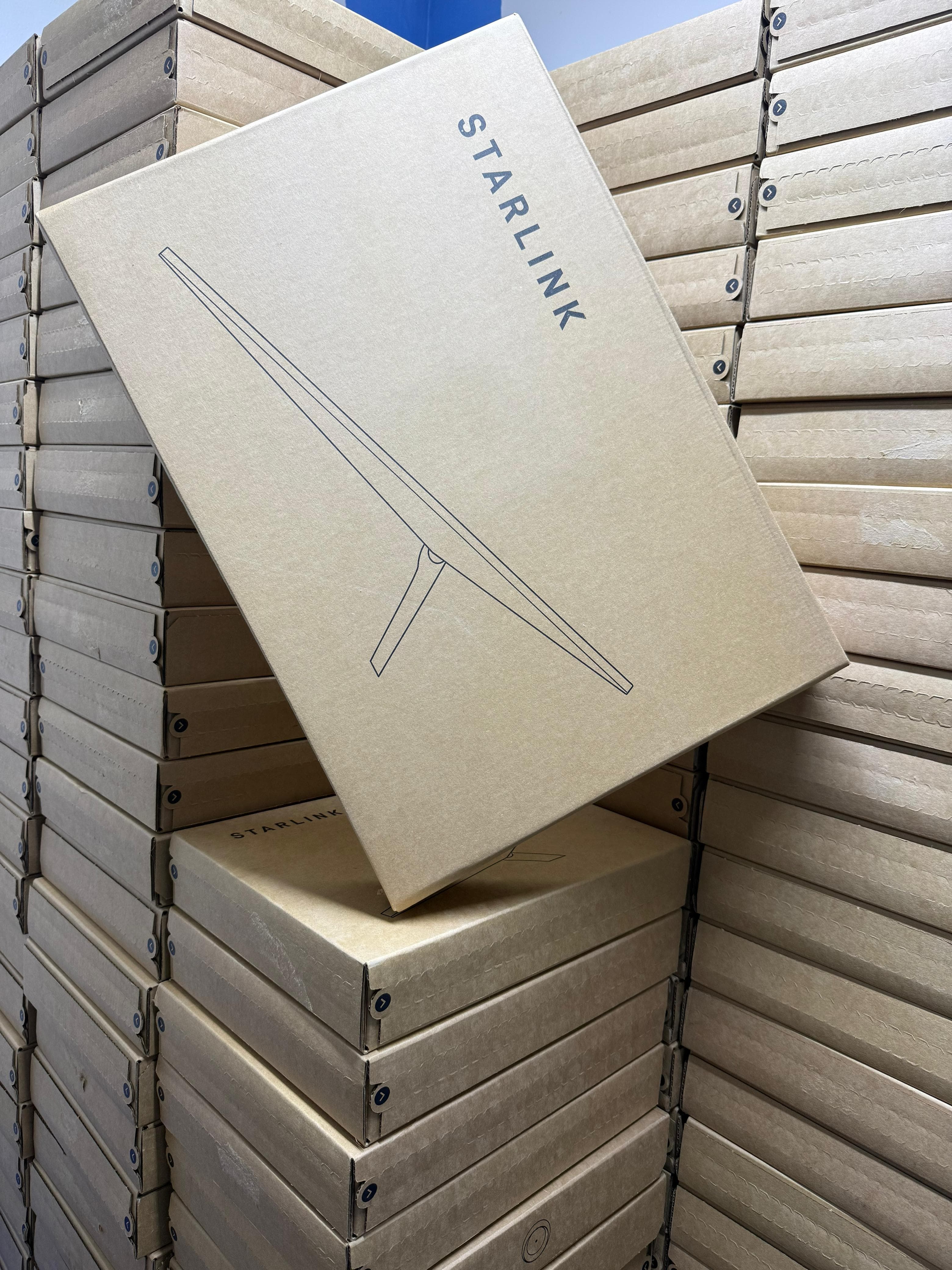 Single Starlink box displayed in front of stacked inventory