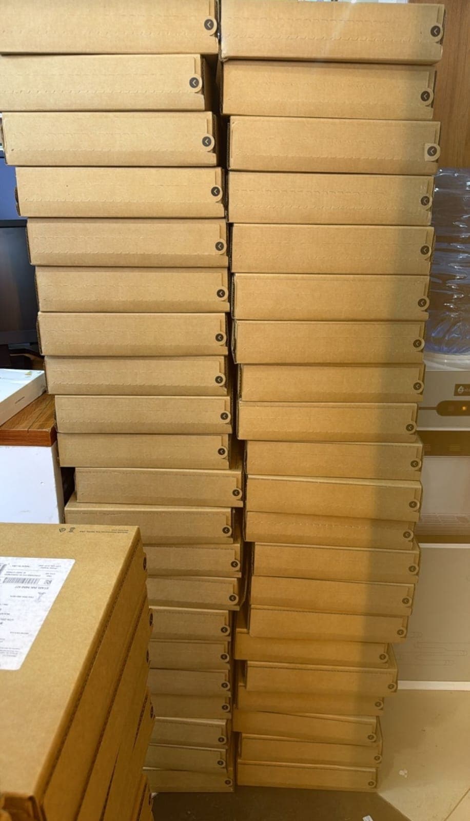 Two tall columns of Starlink boxes in shop storage