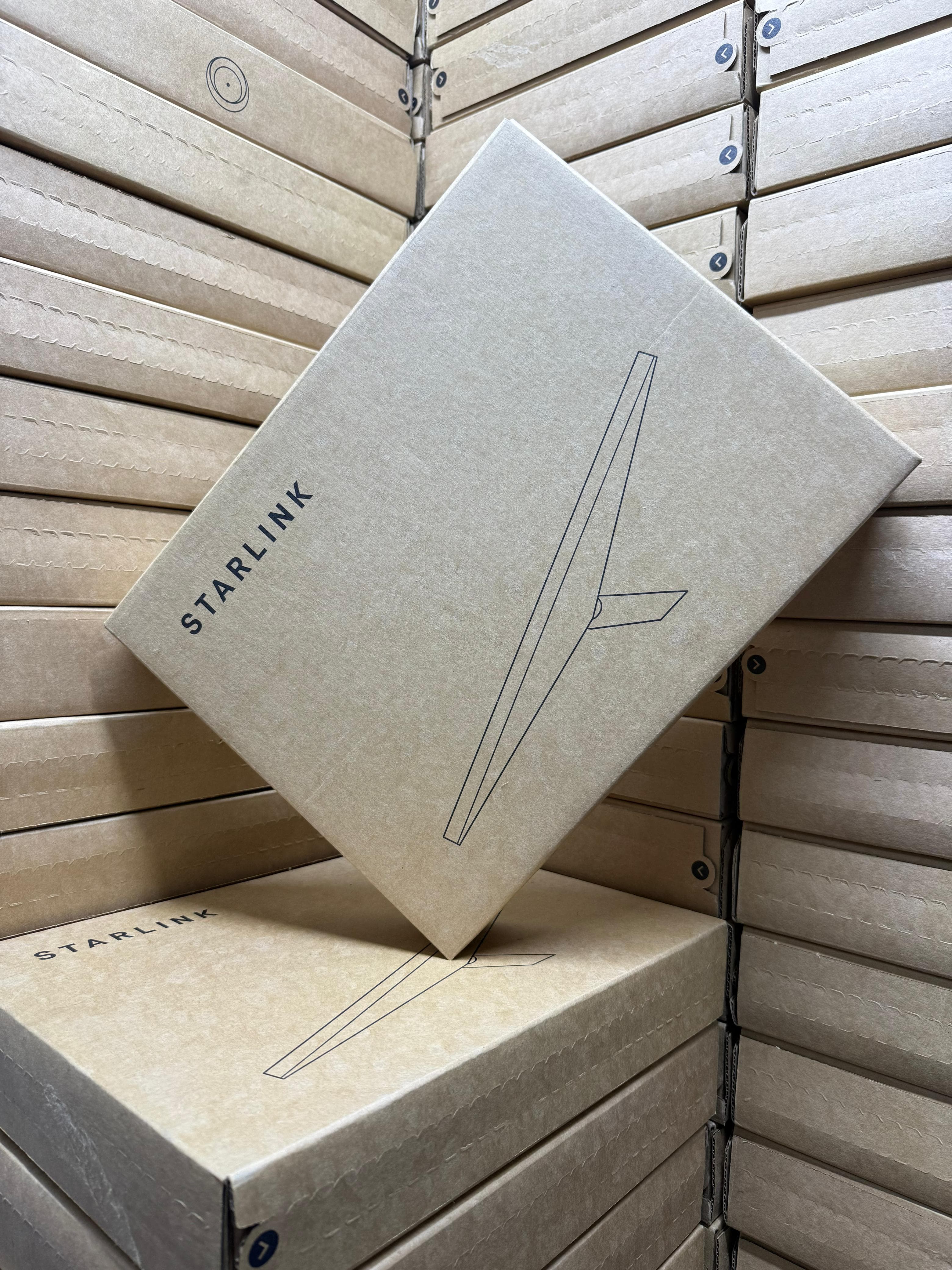 Starlink box displayed diagonally against stocked shelves