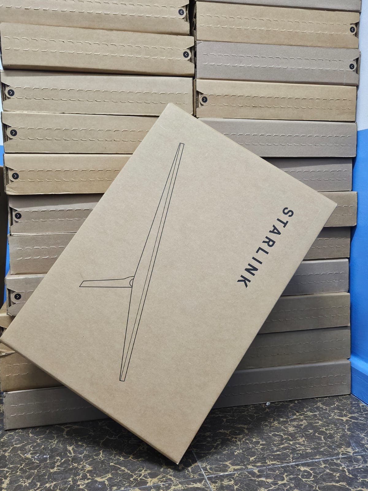 Starlink box leaning against a stacked inventory wall