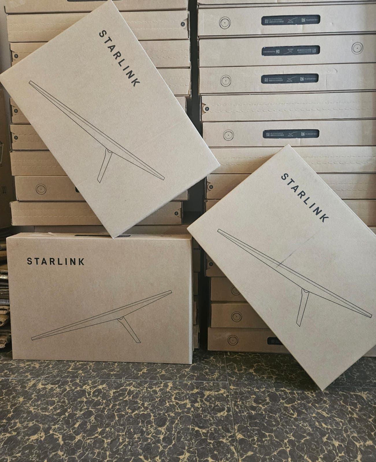 Three Starlink boxes displayed in front of stock