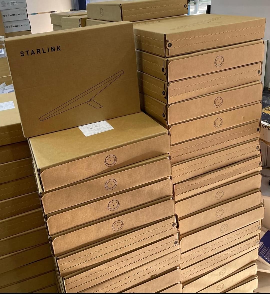 Starlink boxes stacked in a shop storage area