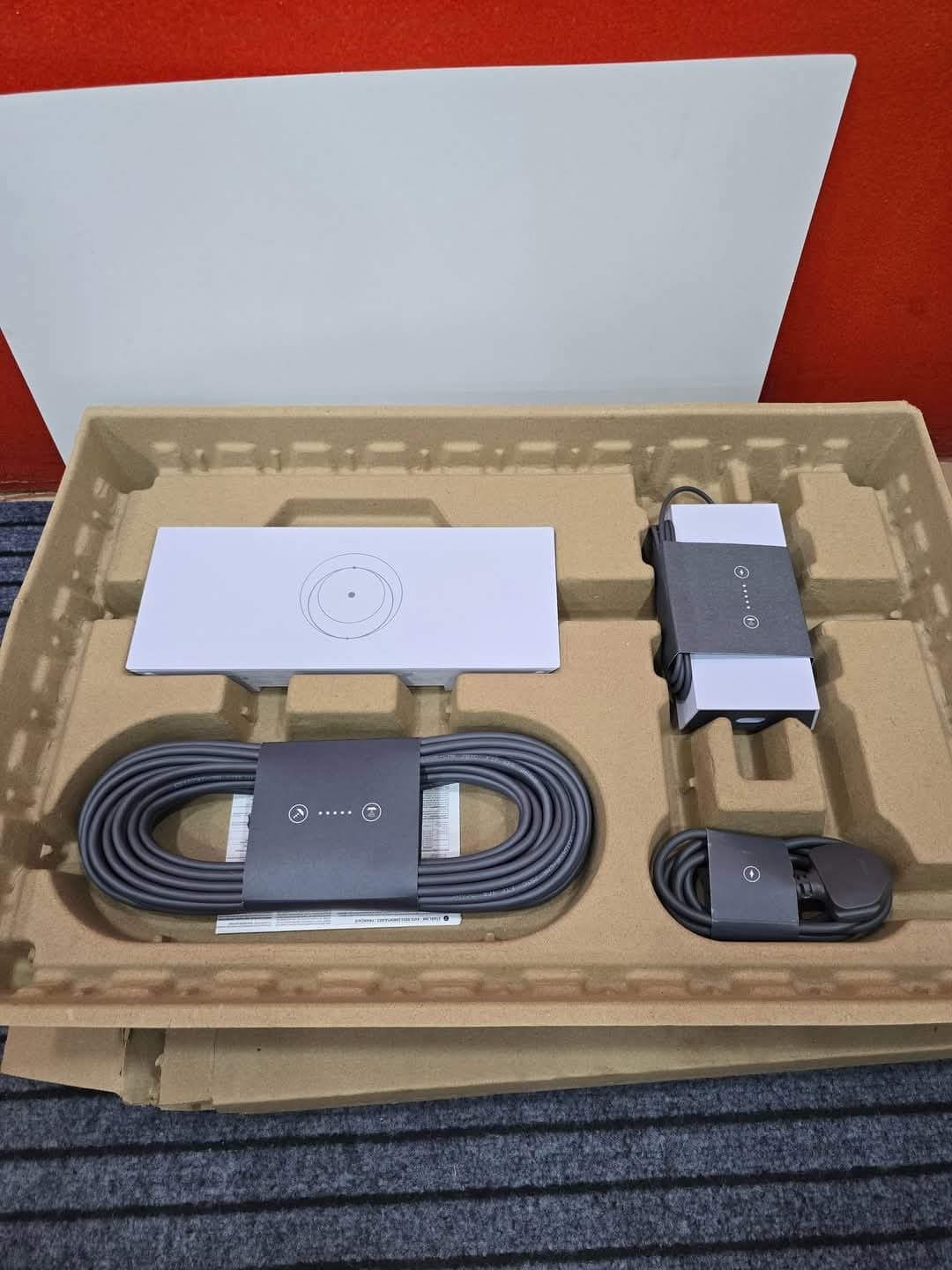 Open Starlink kit with dish, router, and cables