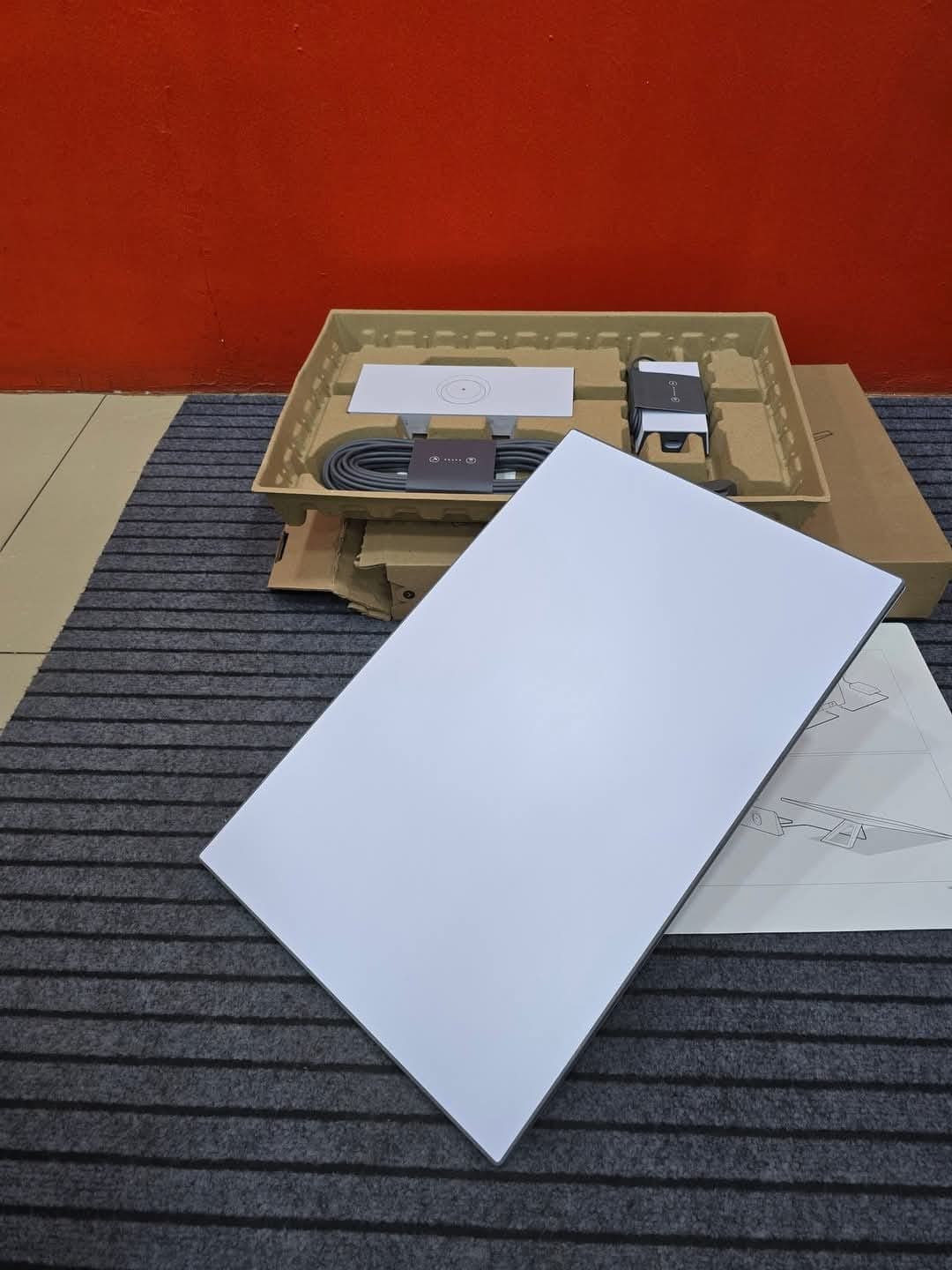 Starlink kit unpacked on a mat with accessories visible