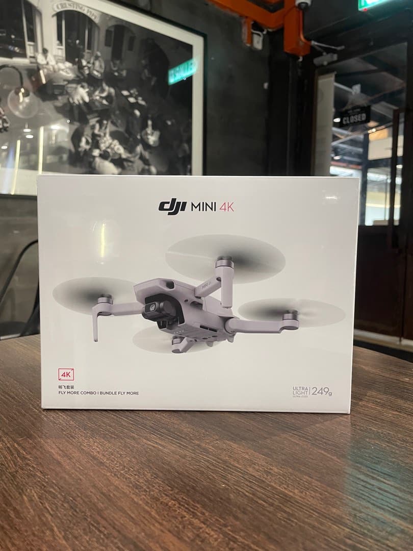 Sealed DJI Mini 4K Fly More Combo retail box photographed in the shop